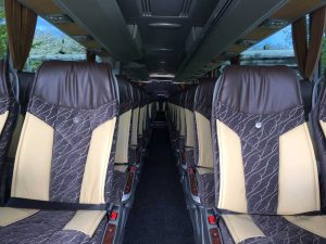 Our luxury coach has comfortable seats with belts and trays.